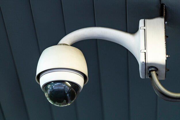 a white camera on a wall