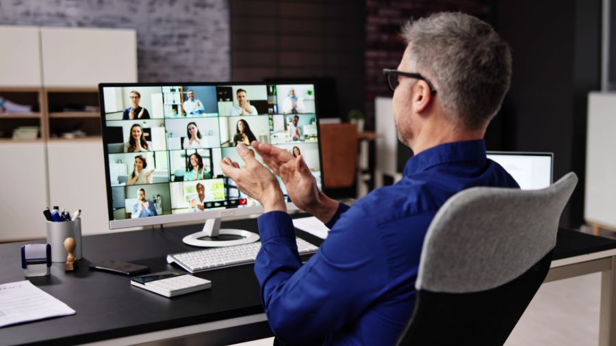 Man video conferencing with multiple participants
